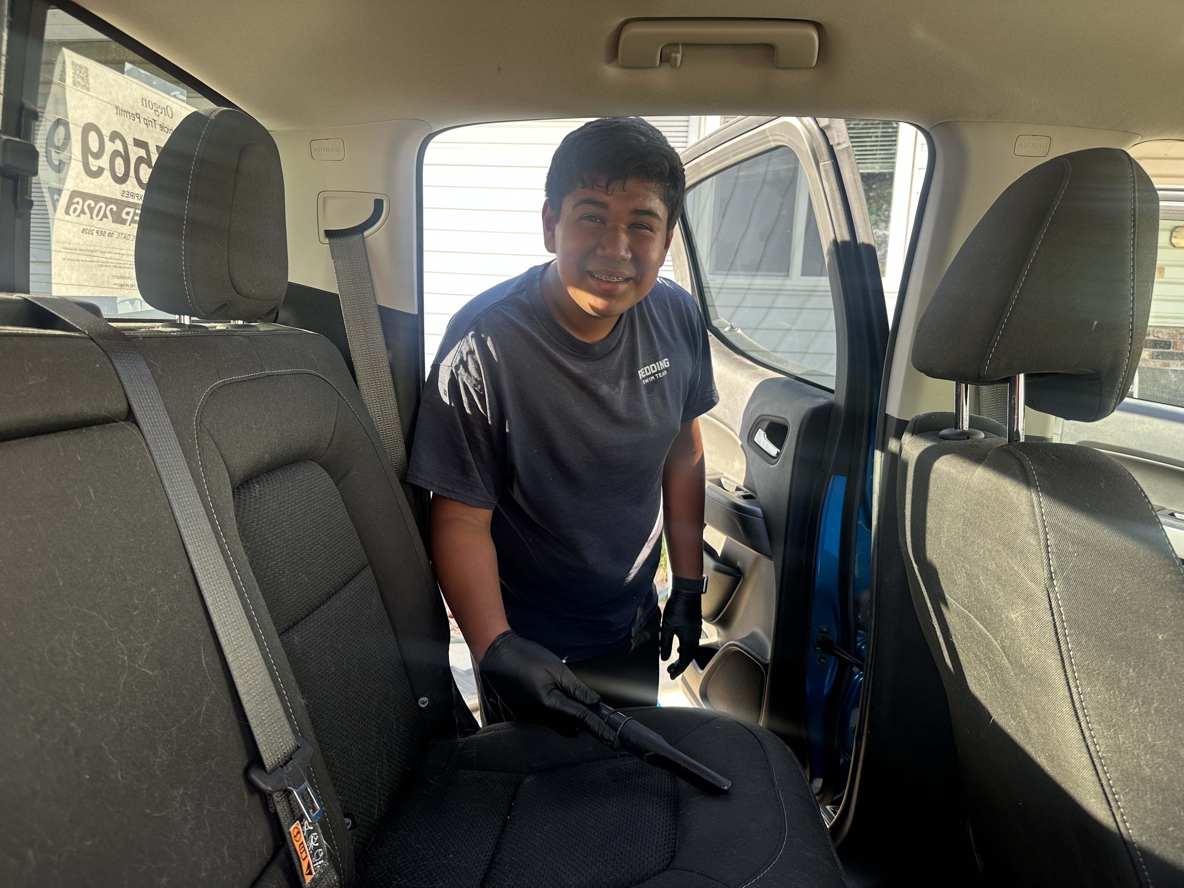 Jonah cleaning inside a vehicle